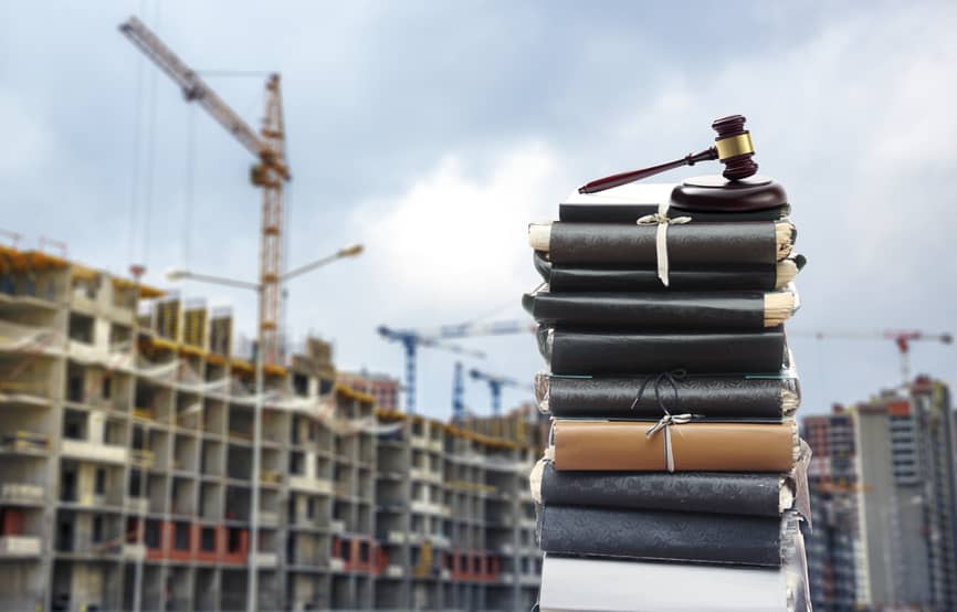 Files with gavel, buildings and cranes